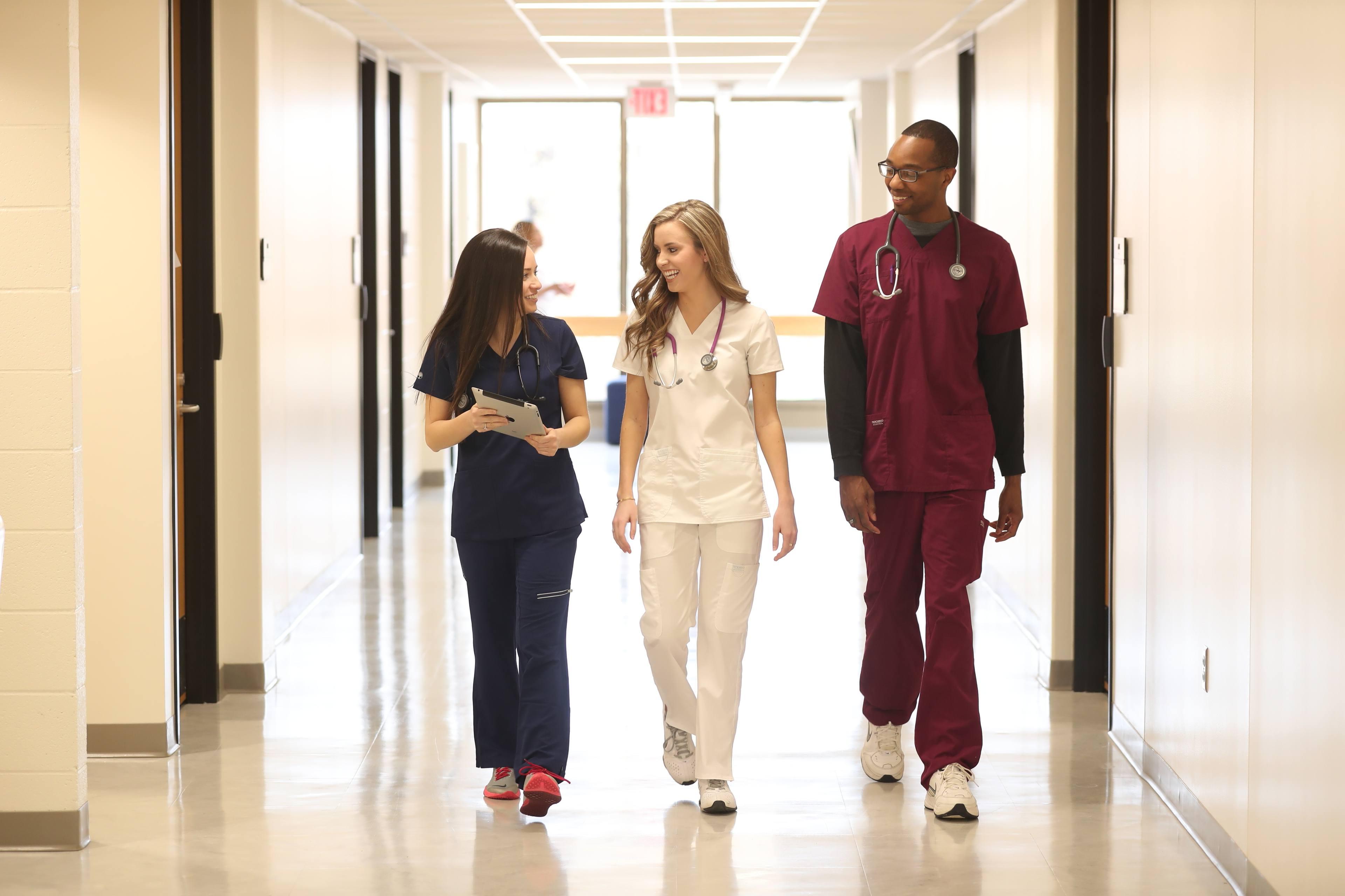 Three Bachelor of Science in nursing students walking towards the BGSU simulation laboratory on our Ohio campus. 